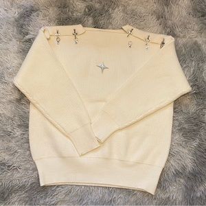 White sweater with stars on shoulder